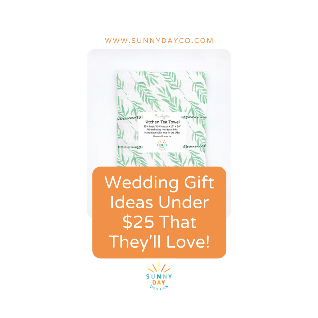 An image for a blog post titled "Wedding Gift Ideas Under $25 That They'll Love!" by Sunny Day Designs. This image shows a green and white watercolor eucalyptus leaf printed kitchen tea towel/dish towel with an orange text box.
