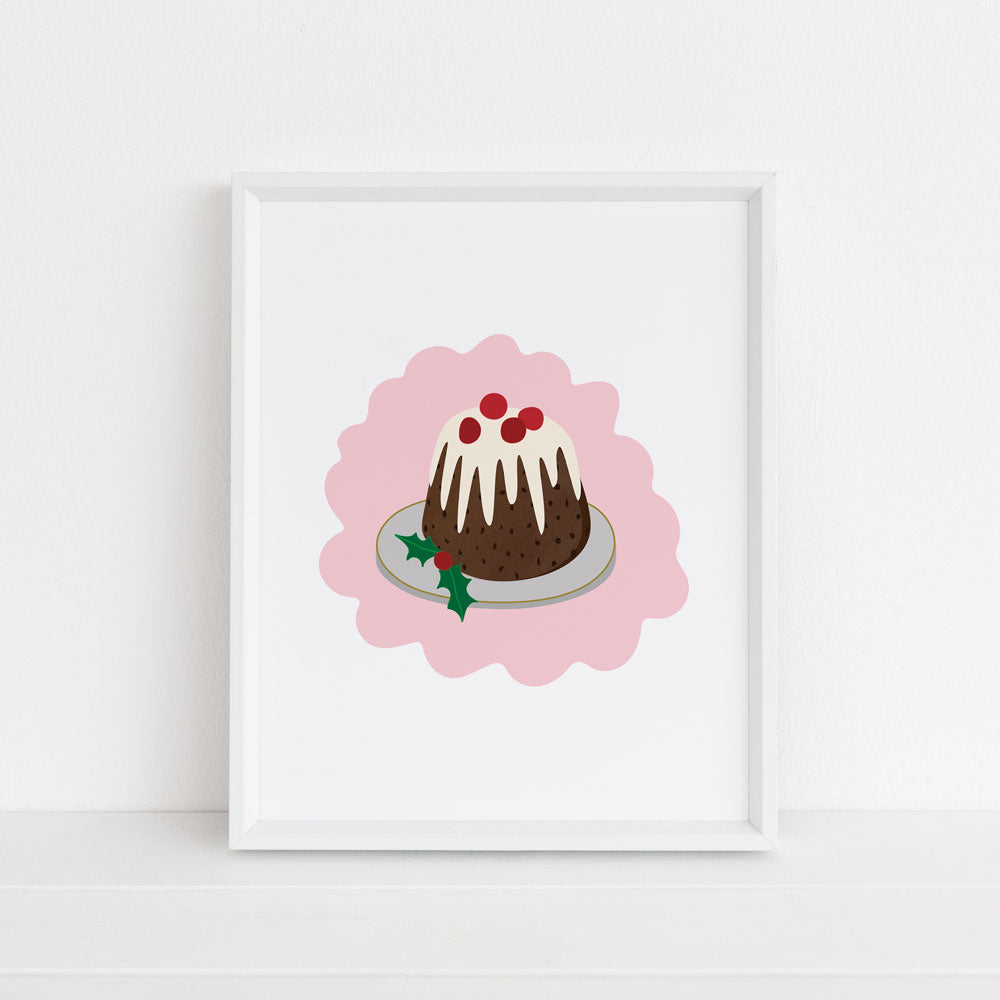 An illustrated & framed 8x10 holiday art print featuring a retro, traditonal brown christmas pudding dessert topped with white brandy sauce and decorated with cranberries and holly berries/leaves against a pink and white background. This wall art illlustration is made in the USA and designed by by Sunny Day Designs.