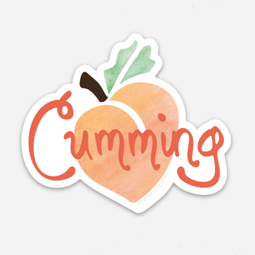 Vinyl sticker featuring a watercolor peach and hand lettered "Cumming" text representing the city of Cumming, Georgia. Made in the USA and designed by Sunny Day Designs.