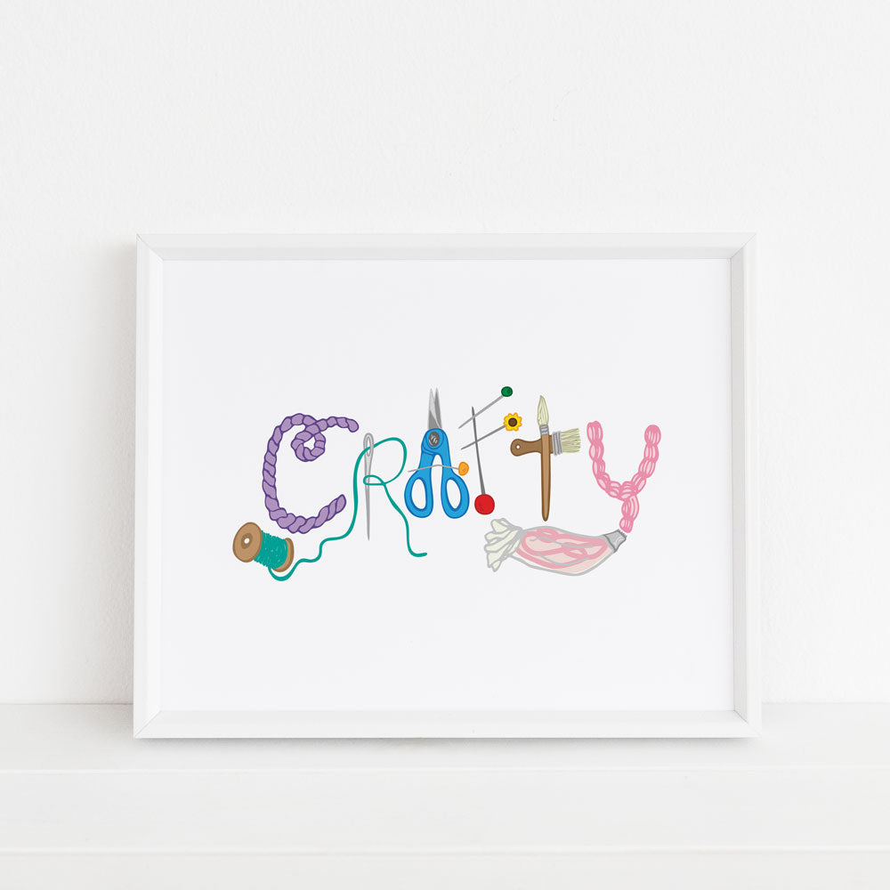 Crafty 8x10 illustrated art print by Sunny Day Designs. Each letter that spells out the word "CRAFTY" is made from a creative illustration: yarn, needle and thread, scissors, sewing pins, paintbrushes, and an icing piping bag with pink icing. Display this art print to show off your creativity and crafty personality! Made in the USA and printed on watercolor paper.
