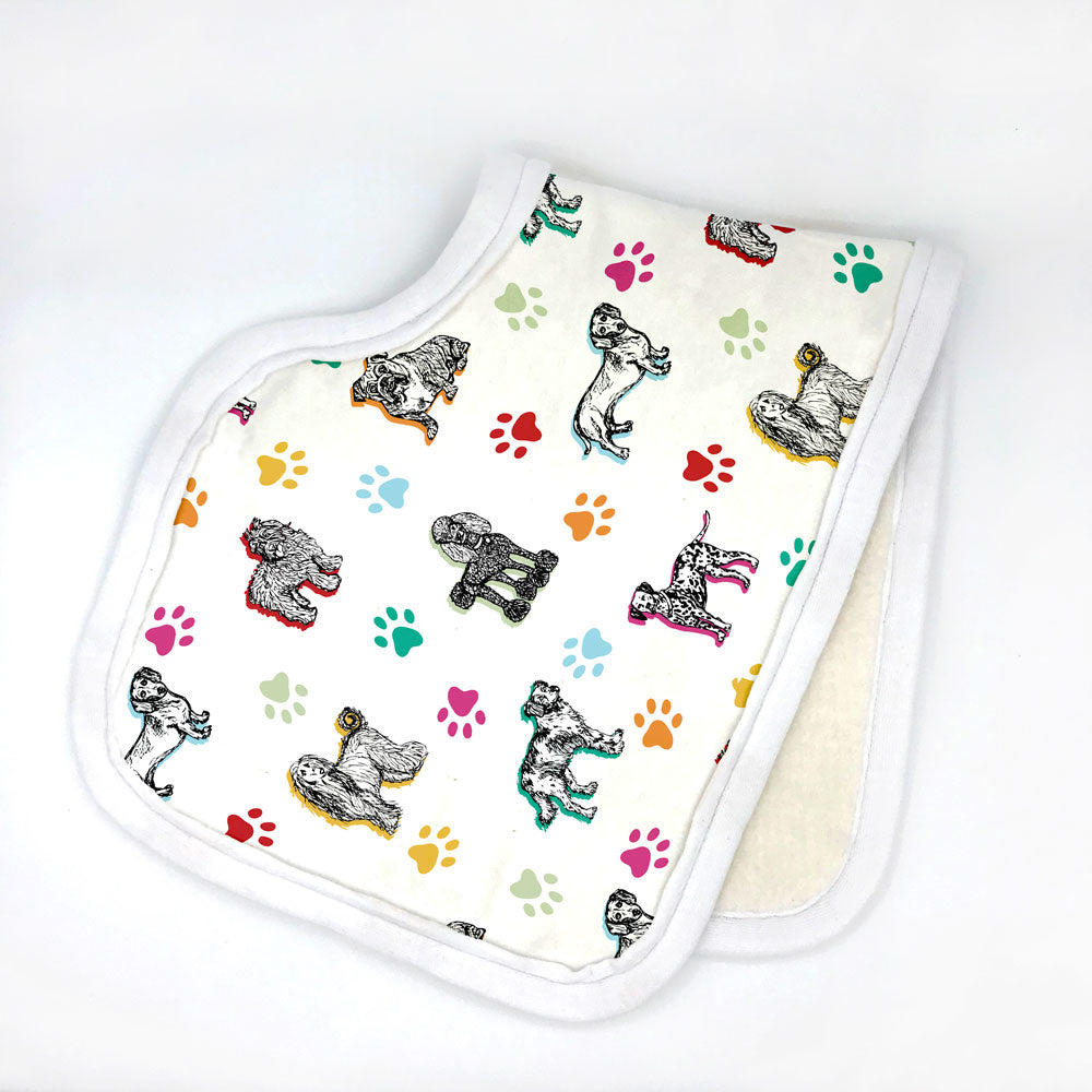 Cuddly Canines dog-themed printed burp cloth is folded in half and photographed against a white backround. This adorable dog print burp cloth is made from organic cotton and features a contoured shape that hugs your neck. Made in the USA by Sunny Day Designs .