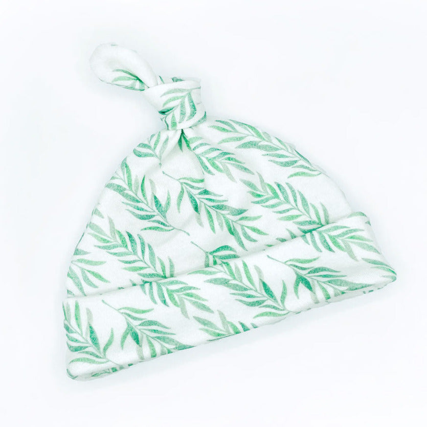 Green Eucalyptus organic cotton baby hat by Sunny Day Designs is shown tilted on a white background.