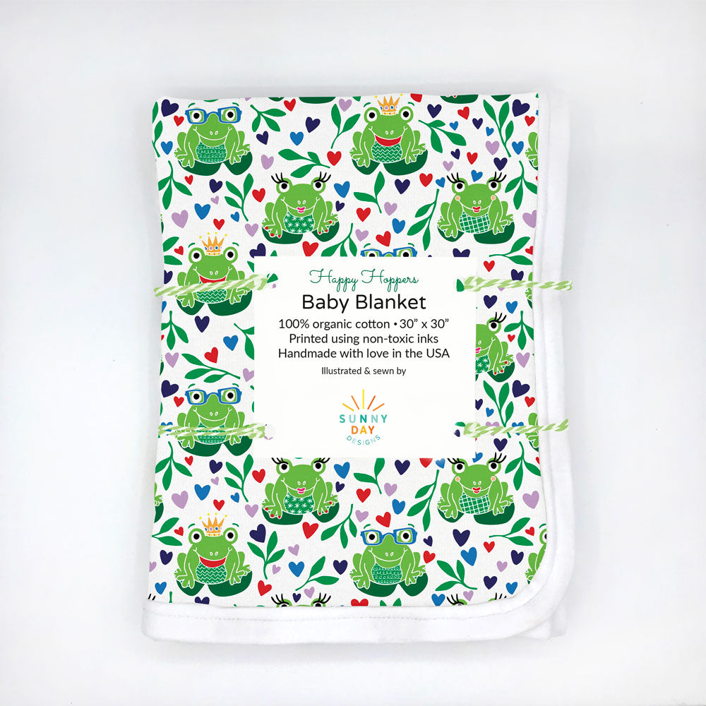 happy hoppers baby blanket with green frogs, hearts, and plants on white background by Sunny Day Designs