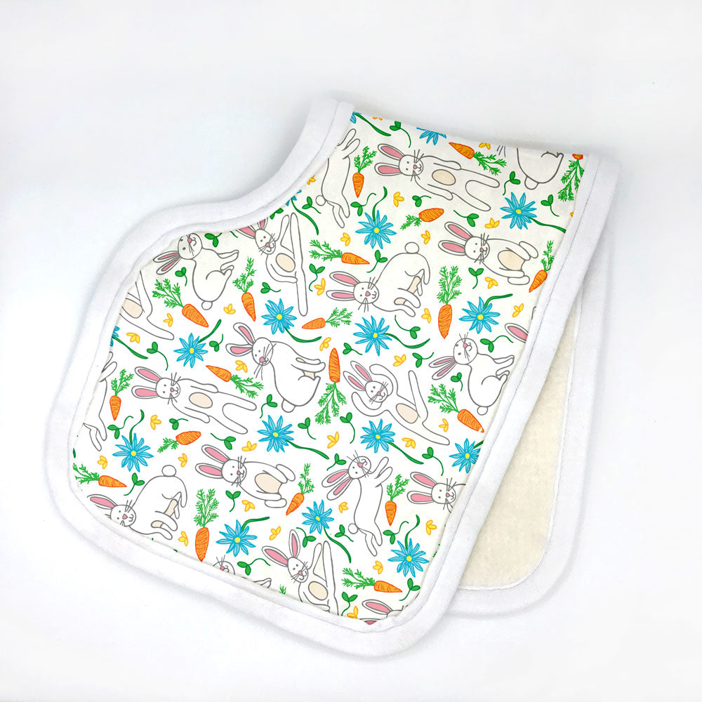 A colorful, Spring bunny rabbit printed organic cotton burp cloth by Sunny Day Designs is shown folded in half against a white background. This adorable print is perfect for Spring babies or to use during the Easter season. Made in the USA.