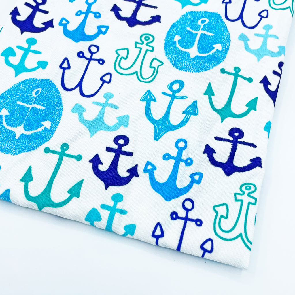 Anchors Away Printed Blue, Turquoise and White linen/cotton tea towel by Sunny Day Designs - Photo shows a folded corner of the towel on a white background. Made in the USA.