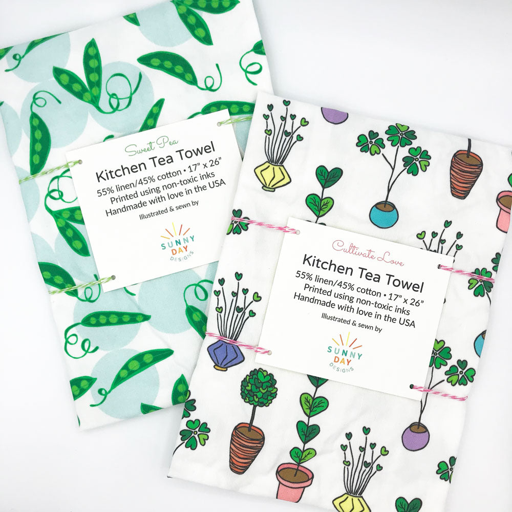 Kitchen Tea Towel bundle by Sunny Day Designs: 1 "Sweet Pea" green/blue pea pod printed fun tea towel & 1 "Cultivate Love" printed fun tea towel (featuring colorful potted plants with heart-shaped green leaves on a white background)