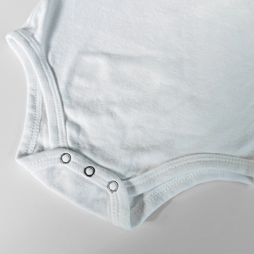 A cat-themed baby onesie is printed with a gray cat wearing yellow sunglasses, 3 colorful hearts, and black "One Cool Cat" text. Shown on a white background.