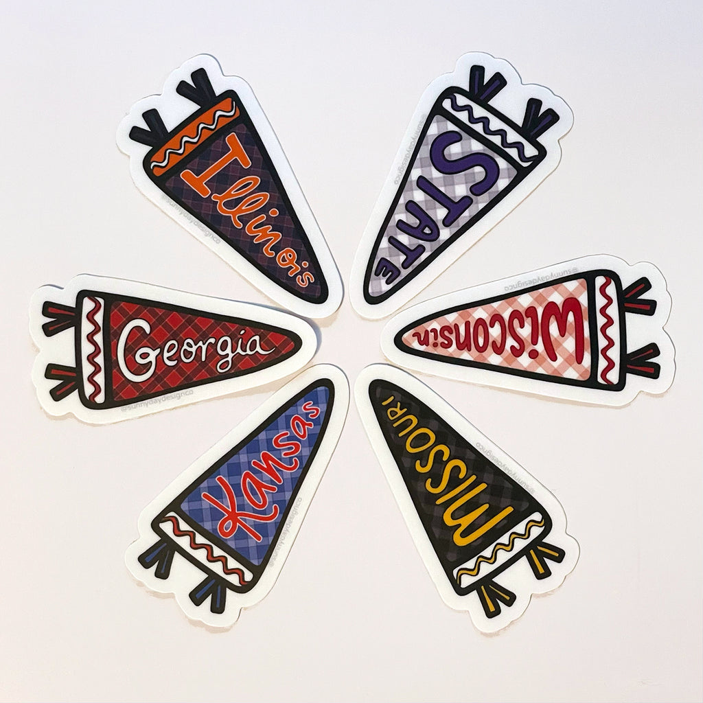 A wheel shaped configuration of 6 pennant-shaped college/university-themed vinyl stickers designed by Sunny Day Designs. Clockwise from top left, the designs shown in the image are:
1. Illinois Pennant sticker
2. KS State Pennant sticker 
3. Wisconsin Pennant sticker
4. Missouri Pennant sticker
5. Kansas Pennant
6. Georgia Pennant