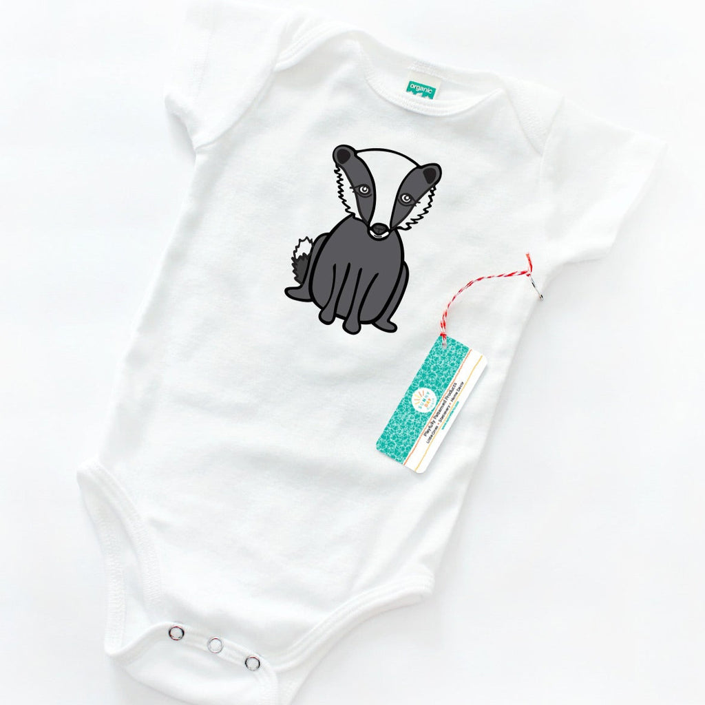 A gray and white cute badger animal baby onesie made from organic cotton is shown on a white background. This baby onesie makes a perfect baby shower gift for UW Madison fans, Spring Hill College fans & Snow College fans