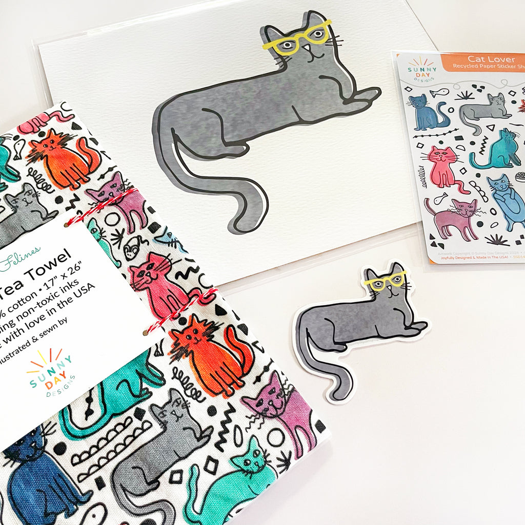 The at Lover gift set product bundle of 4 colorful cat-themed gifts by Sunny Day Designs is shown tilted and close up on a white background