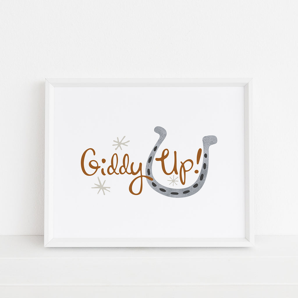 A horse-themed illustration by Sunny Day Designs is shown inside a white frame. The 8x10 sized equestrian-themed illustration says "Giddy Up!" in brown hand lettered text and features a gray watercolor horseshoe.