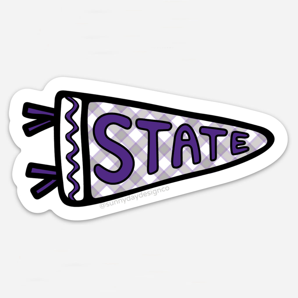 Vinyl magnet in the shape of a pennant flag featuring a purple and lavender checkered background with the word “STATE” in bold purple block lettering and decorative tassels. Die-cut with a white border, designed by Sunny Day Designs as a tribute to Kansas State University.