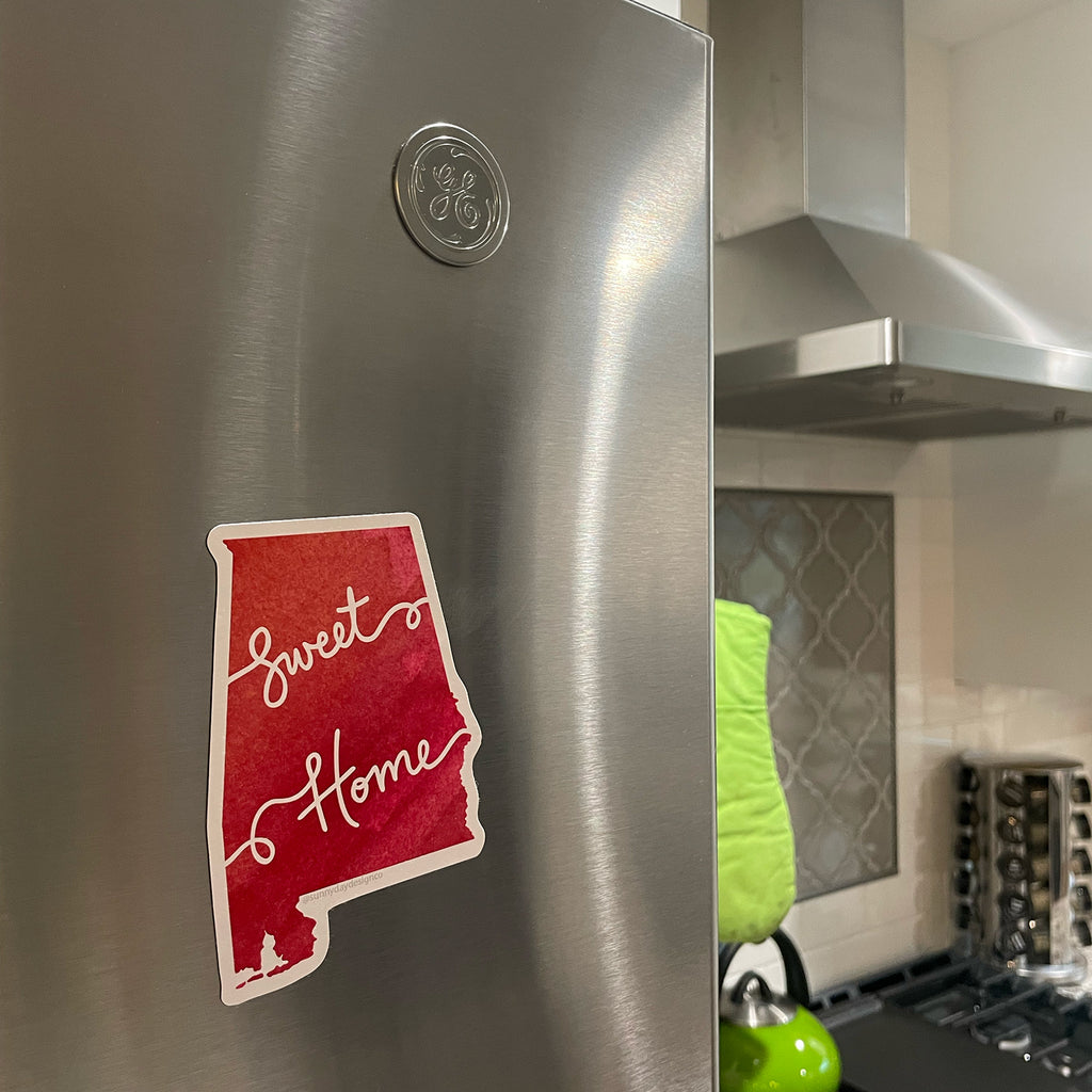Crimson red Sweet Home Alabama watercolor fun vinyl magnet by Sunny Day Designs. This AL state shaped magnet is perfect for anyone from Alabama. Made in the USA.