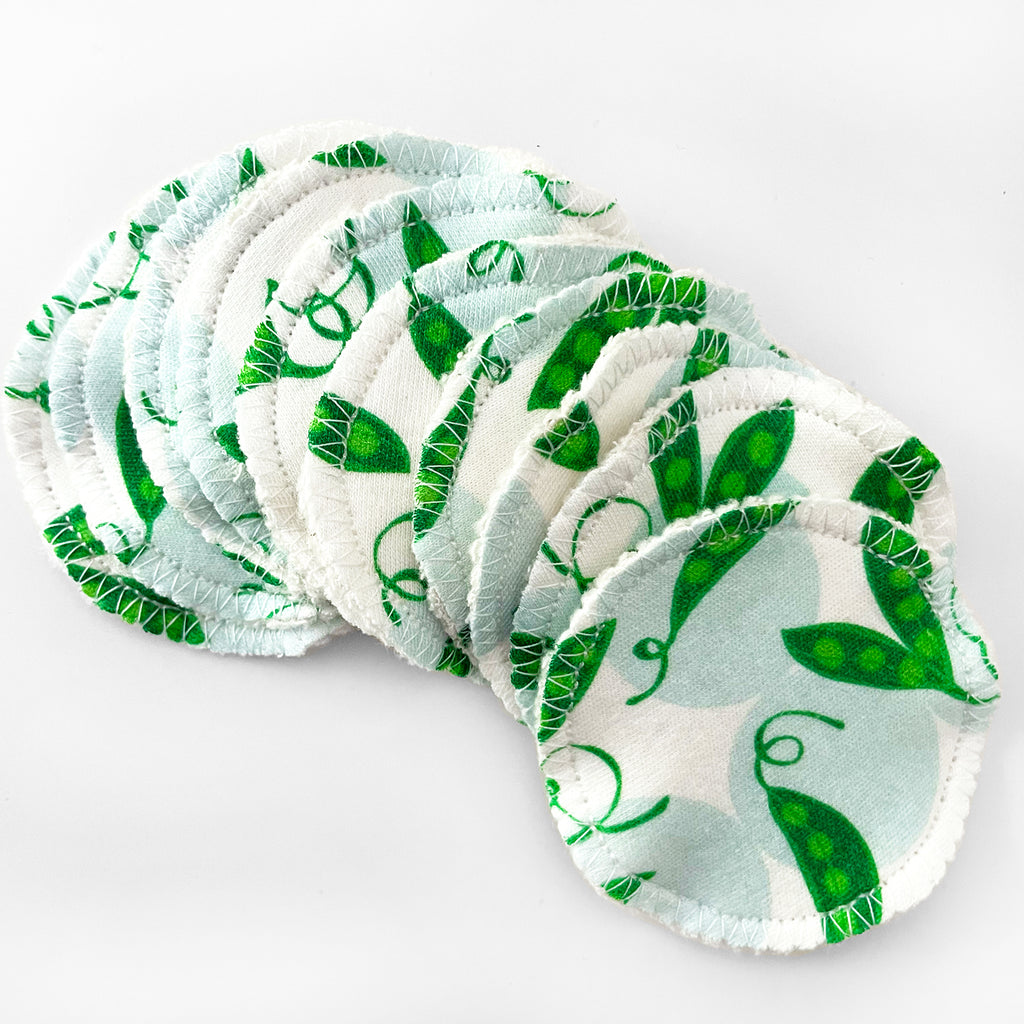 A set of 10 green/blue/white colorfully printed organic cotton facial round reusable makeup wipes are printed with a cute sweet pea vegetable design, making this set of 10 face wipes a great self care gift or a unique gift for gardeners or plant lovers!