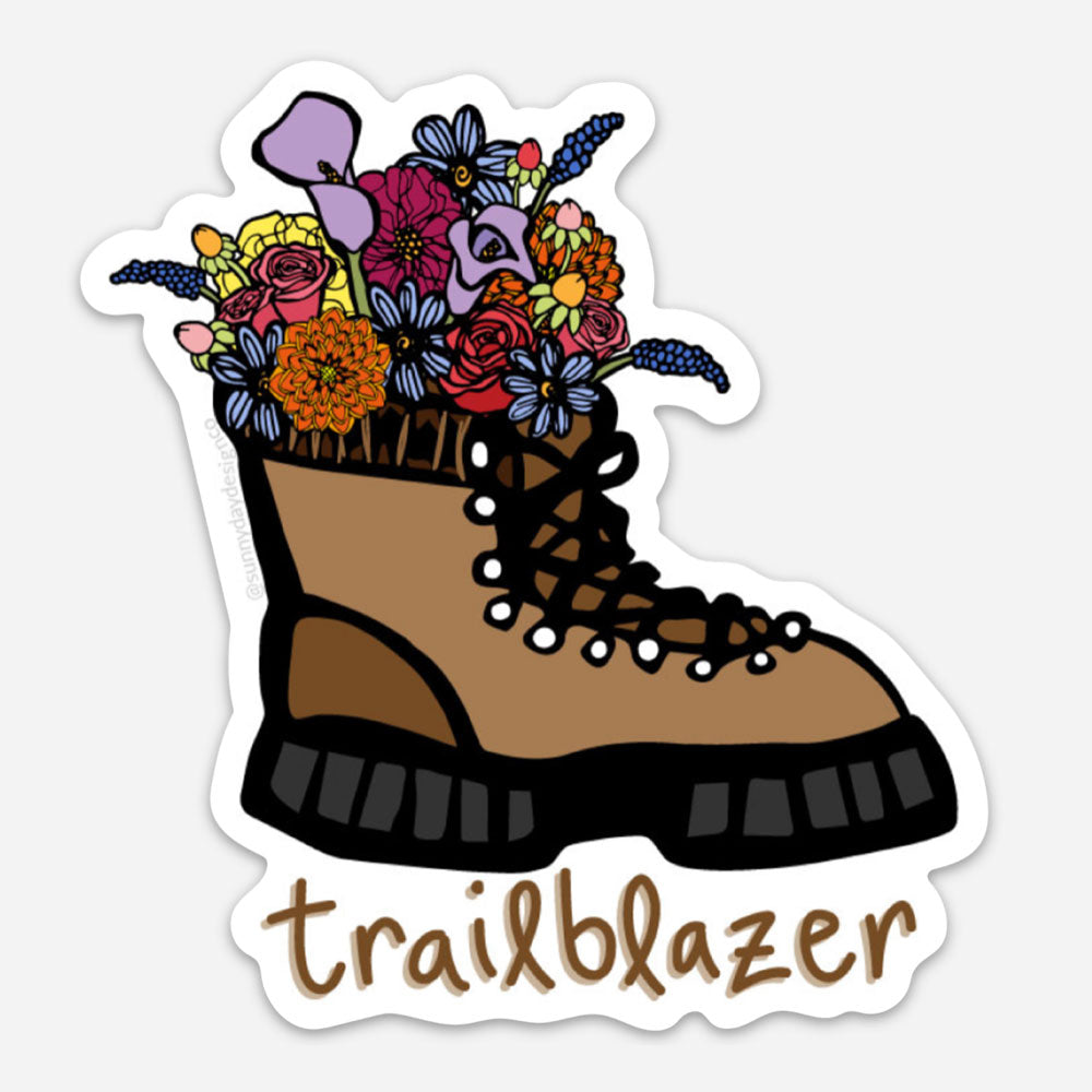 Brown hiking boot vinyl magnet with colorful wildflowers coming out of the top and hand lettered "Trailblazer" text at the bottom. Magnet designed by Sunny Day Designs and made in the USA.