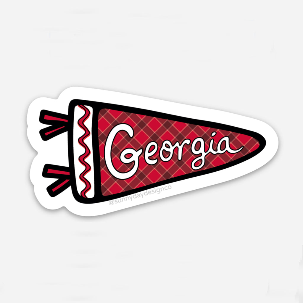 A red, black & white plaid sports pennant-shaped vinyl sticker featuring the word "Georgia" in red is shown on a white background. This cute college-themed sticker is perfect for bulldog fans, alumni & students at the University of Georgia in Athens, GA. Each waterproof, scratch-resistant sticker is joyfully made in the USA. Designed by Sunny Day Designs in Madison, WI.