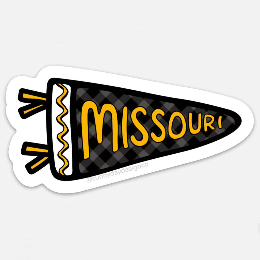 A black, yellow and white sports pennant-shaped thin vinyl magnet featuring the word "Missouri" in golden yellow hand lettering is shown on a white background. This cute college-themed sticker is perfect for tigers fans, Missouri alumni & university students in Columbia, MO. Each waterproof, scratch-resistant magnet is joyfully made in the USA. Designed by Sunny Day Designs in Madison, WI.