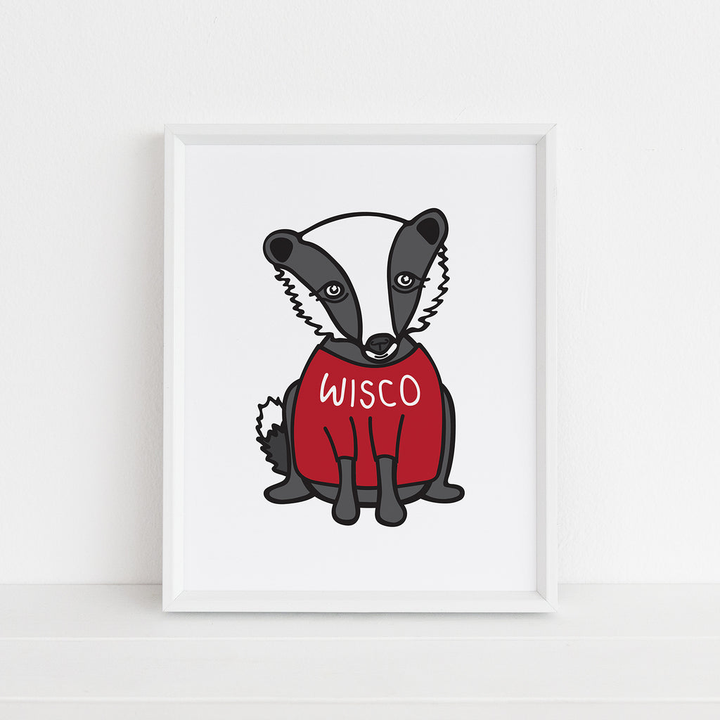 an 8x10 inch sized illustrated animal art print of a cute gray/black/white badger wearing a red shirt with white WISCO text on it. This print is perfect for fans of the University of Wisconsin - Madison (IW Madison)
