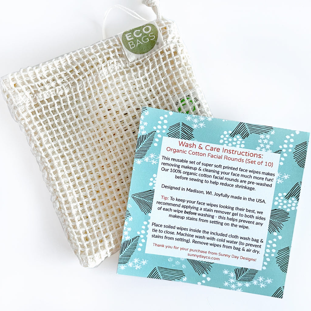 A turquoise patterned square card is shown next to an Eco Bag wash bag with washing and care instructions on how to clean a set of 10 organic cotton facial rounds by Sunny Day Designs
