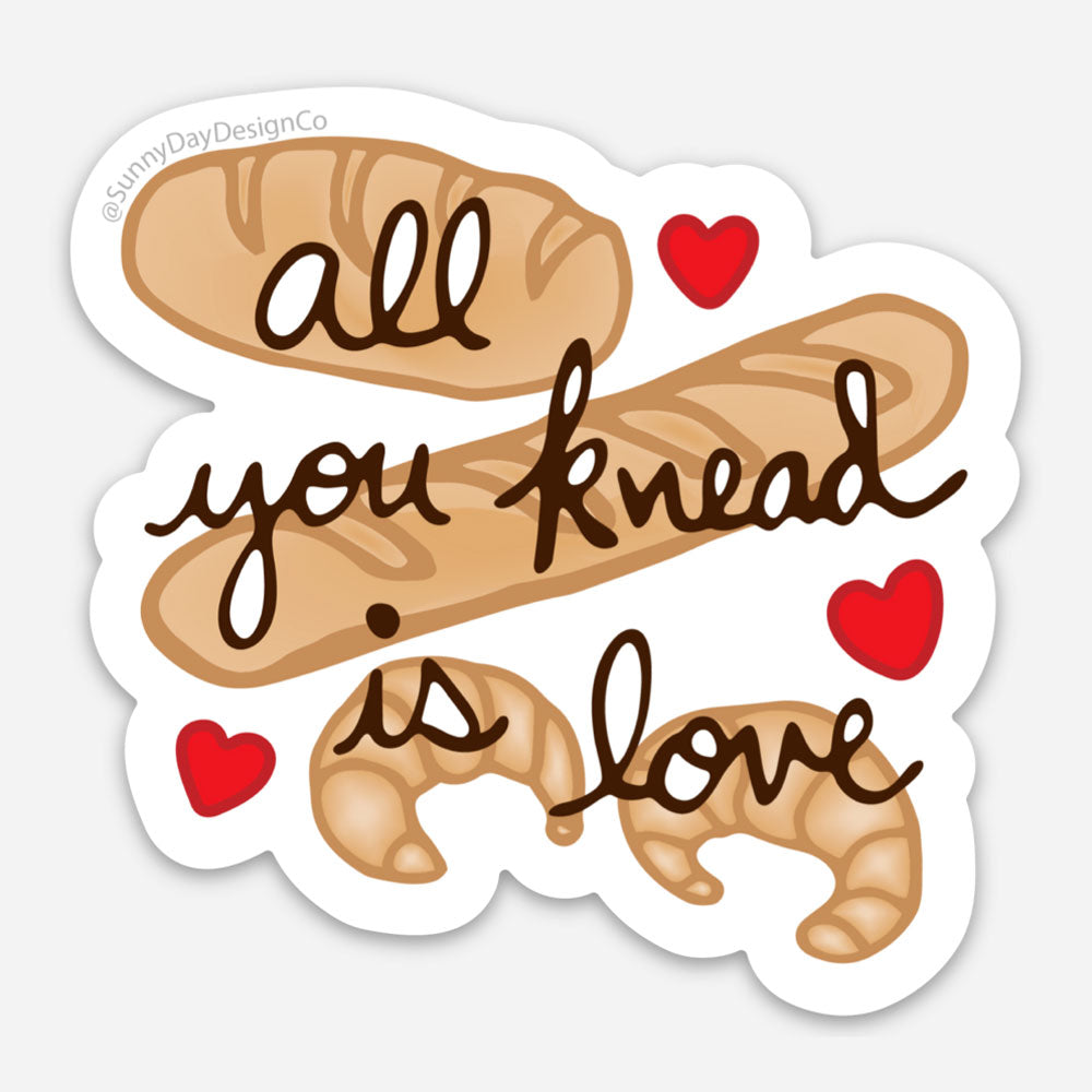 Bread Themed vinyl sticker featuring brown loaves of bread and croissants with the words "All You knead Is Love" and 3 red hearts. Sticker designed by Sunny Day Designs and made in the USA.