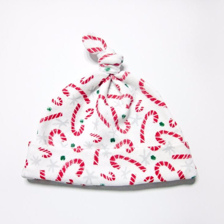 Red candy cane lane organic cotton baby hat on a white background by Sunny Day Designs