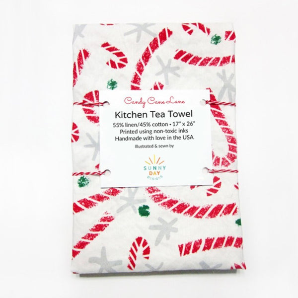 https://sunnydayco.com/cdn/shop/products/Candy-Cane-Lane-Kitchen-Tea-Towel-Packaged-Sunny-Day-Designs-LowRes_grande.jpg?v=1612122531