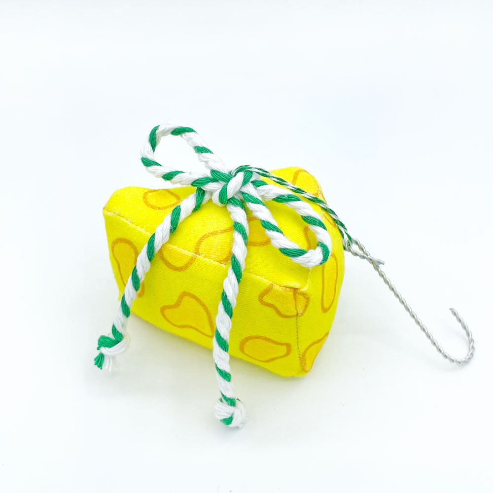 This fun, cheese themed christmas ornament is handmade from organic cotton and features a green/white bow on the top. Made by Sunny Day Designs, this adorable cheese Christmas tree ornament makes a fun gift for people who live in Wisconsin and/or Green Bay Packers fans!