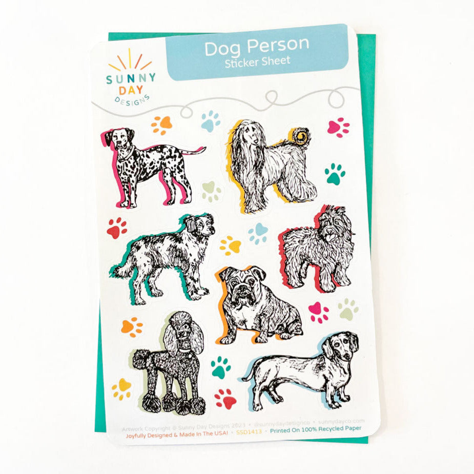 Dog themed sticker sheet made from 100% recycled paper. This "Dog Person" sticker sheet features 7 different dog breeds (Dalmation, Afghan Hound, Brittany, Bulldog, Sheepdog, Poodle & Dachshund), along with colorful paw print stickers. Designed by Sunny Day Designs & made in the USA.
