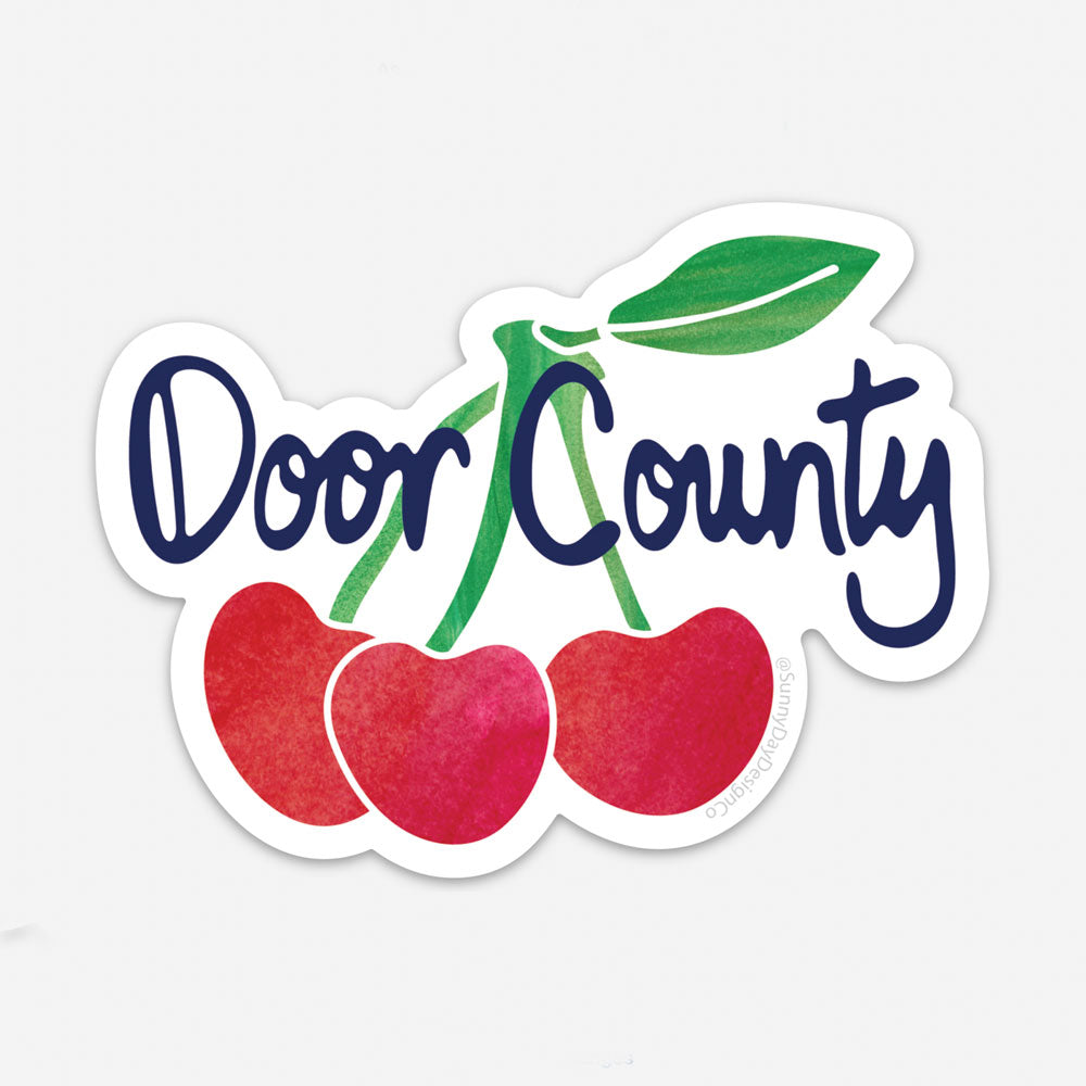 Red, Green & navy blue Door County Wisconsin Cherries Souvenir Vinyl Magnet by Sunny Day Designs. Made in the USA and shown on a white background.
