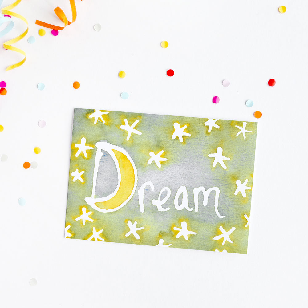 Fun greeting card with watercolor Dream text on a background with colorful confetti