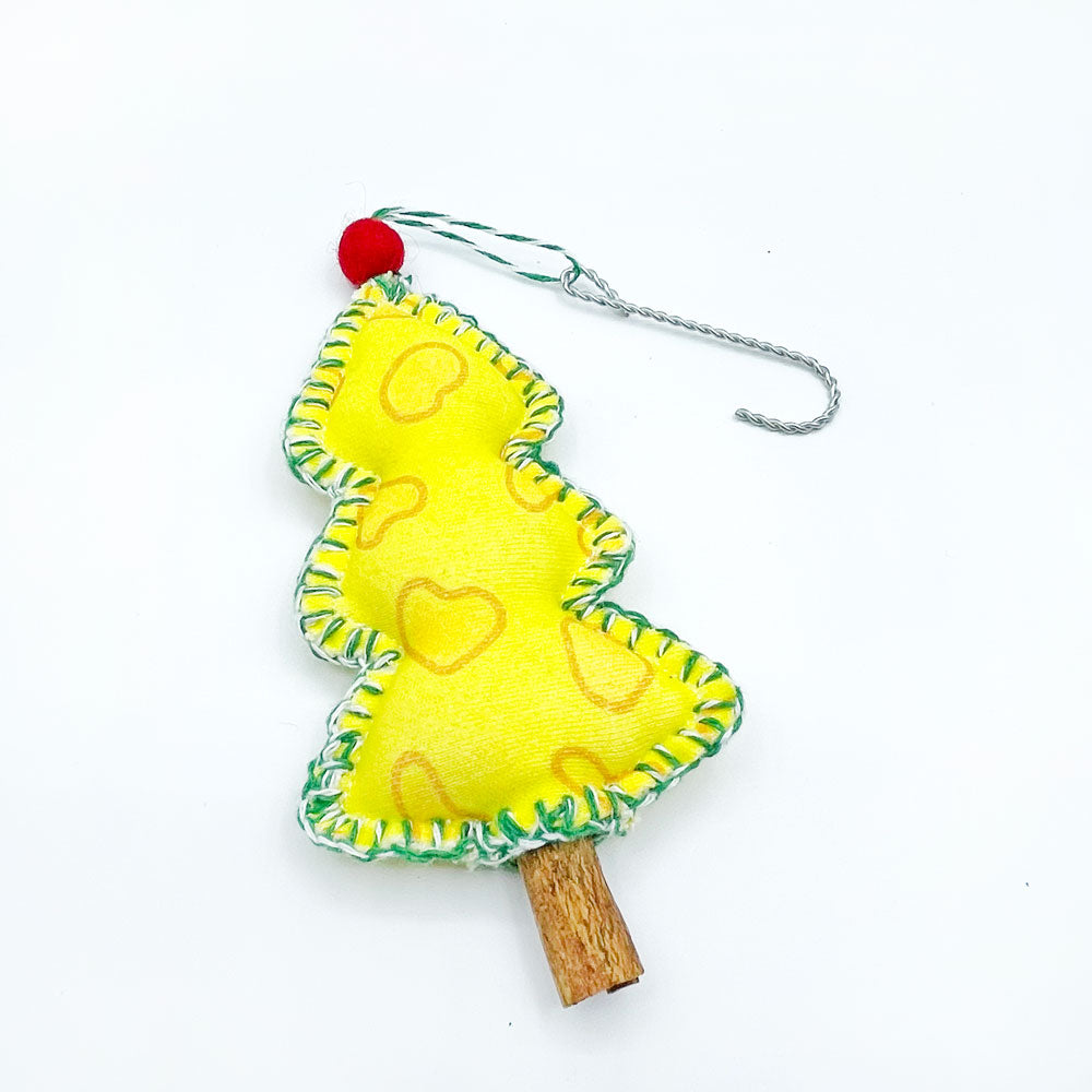 Yellow Cheese Tree Christmas Ornament by Sunny Day Designs laying flat on a white background. This cheesy printed holiday ornament by Sunny Day Designs is stitched with green/white baker's twine, topped with a red wool pom pom, and finished with a cinnamon stick trunk. Handmade in the USA. 