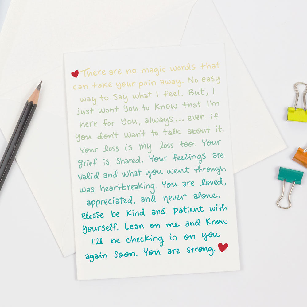 This colorful "From The Heart" sympathy greeting card design is the perfect card to send to friends or family after grief, loss, or a miscarriage. Designed by Sunny Day Designs and made in the USA on sustainably sourced paper, this card features emotional words of support on the front inyellow, green, turquoise and blue and is pictured on a white background next to a pencil and colorful binder clips.