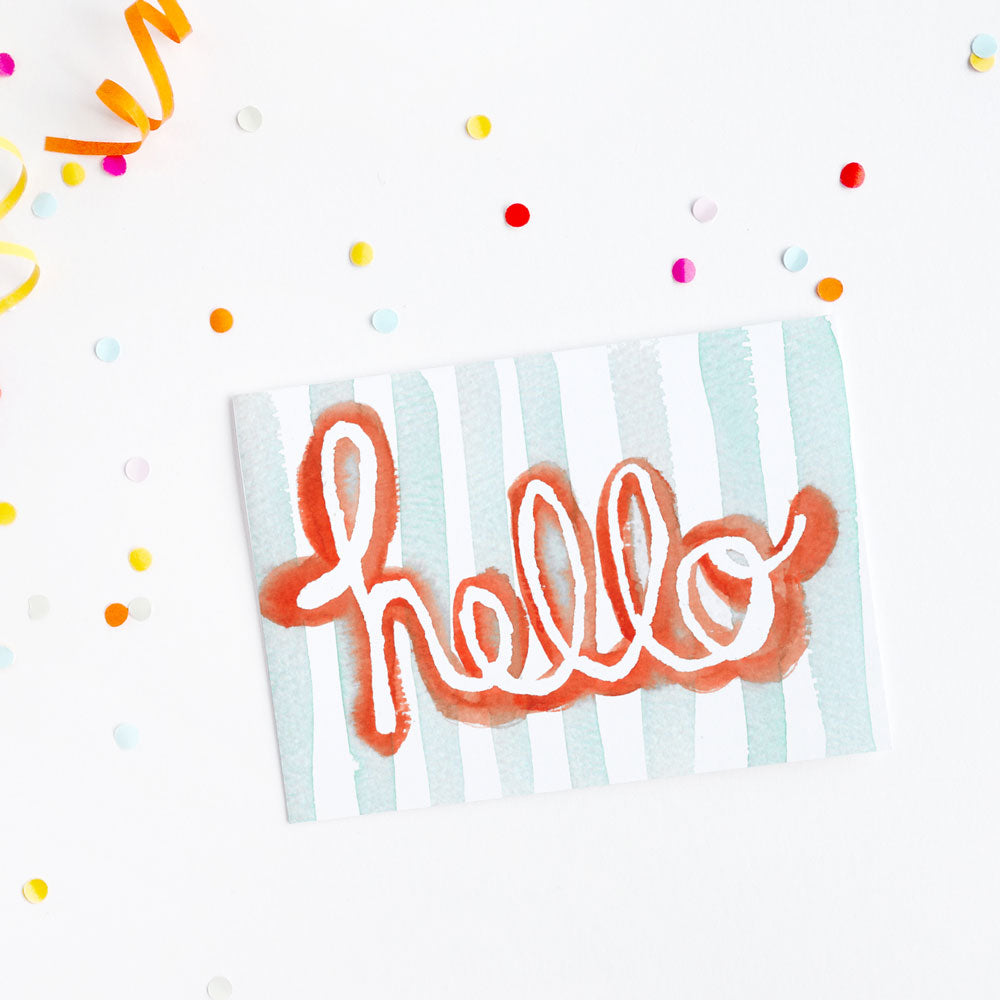 Fun greeting card with watercolor Hello text on a background with colorful confetti