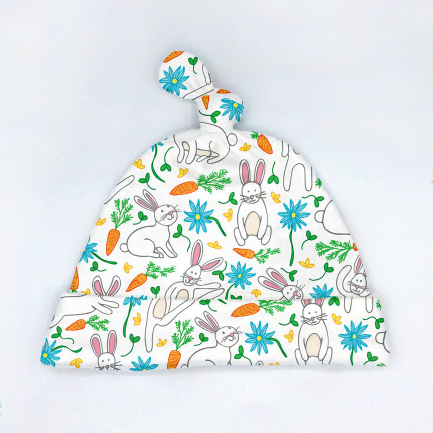 This colorful, Hippity Hop printed organic cotton baby hat is perfect for newborns and features a fun print design with cheerful bunny rabbits, flowers, and carrots that is perfect for Easter or Spring! Designed & handmade by Sunny Day Designs. Made in the USA.