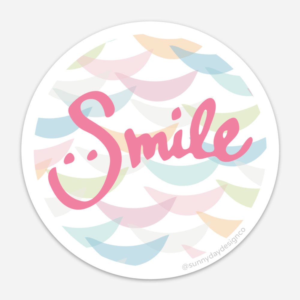 colorful abstract magnet with handwritten smile text in pink on multicolor background
