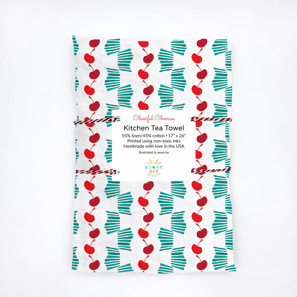 juicy fruit themed tea towel with red and green cherry print on white background