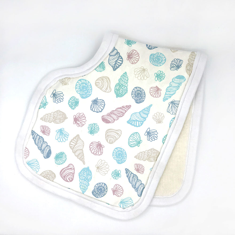 Seashell printed organic cotto burp cloth by Sunny Day Designs. This soft, ocean-themed printed burp cloth is shown folded in half against a white background. Made in the USA from organic cotton.