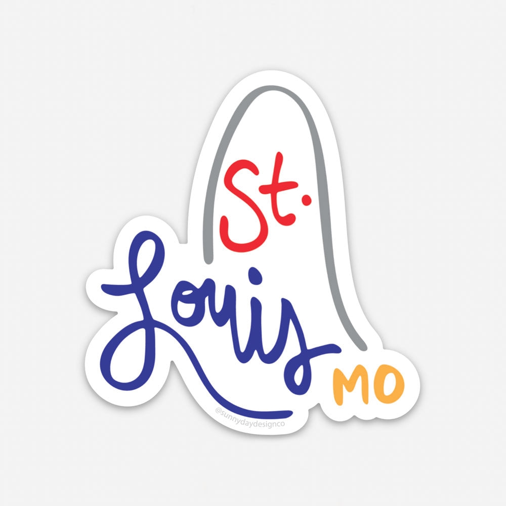 St. Louis, Missouri-themed vinyl sticker featuring an abstract gray gateway arch design with hand lettered "St. Louis MO" text in red, blue, and yellow. This "St. Louis MO" sticker design was created by Sunny Day Designs and is made in the USA