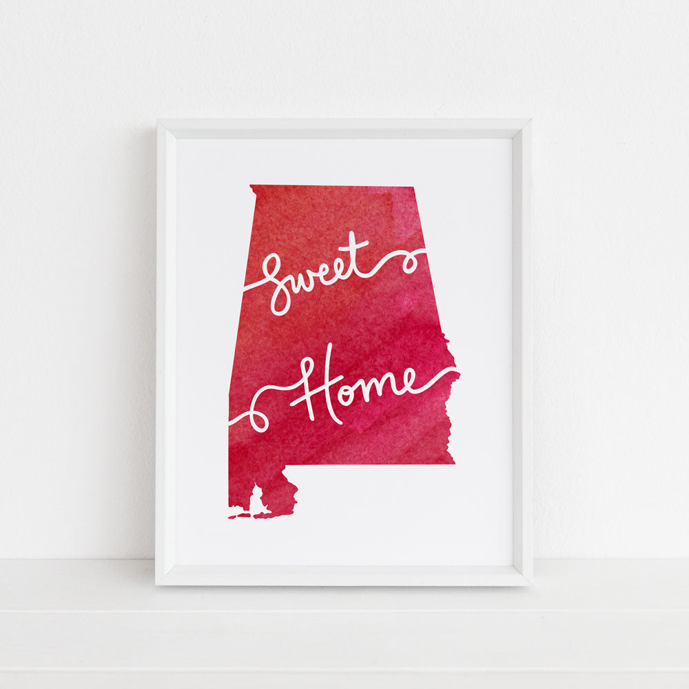 Sweet Home Alabama Crimson Red 8x10 Art Print Designed by Sunny Day Designs and Made in the USA. Red watercolor Alabama state shape with white hand lettered text that says "Sweet Home". Made in the USA.