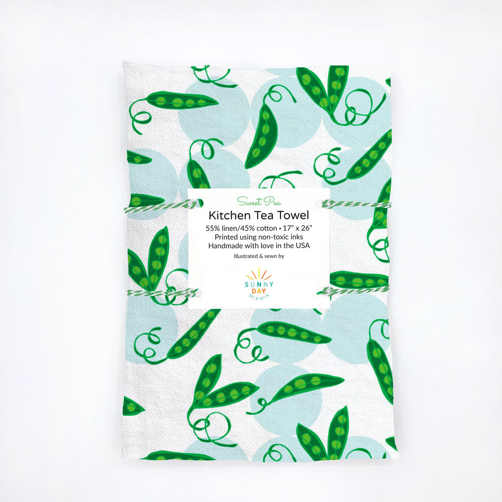 Green, light blue, and white, sweet pea pod-themed kitchen tea towel. This eco-friendly dish towel makes a great  kitchen gift for gardeners and vegetarians! Designed and handmade in the USA from durable and soft linen/cotton fabric.